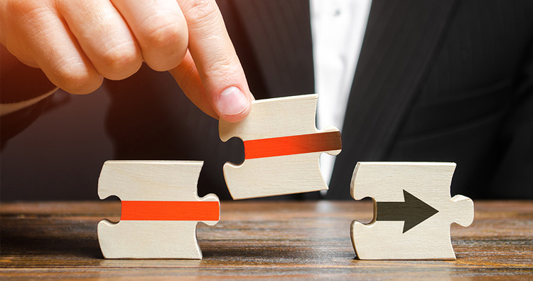 Image of a hand arranging puzzle pieces