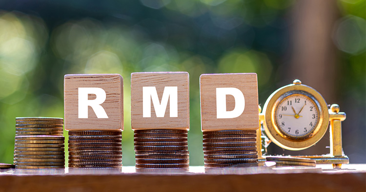 An image of stacked quarters on a table with wood blocks on top spelling R-M-D